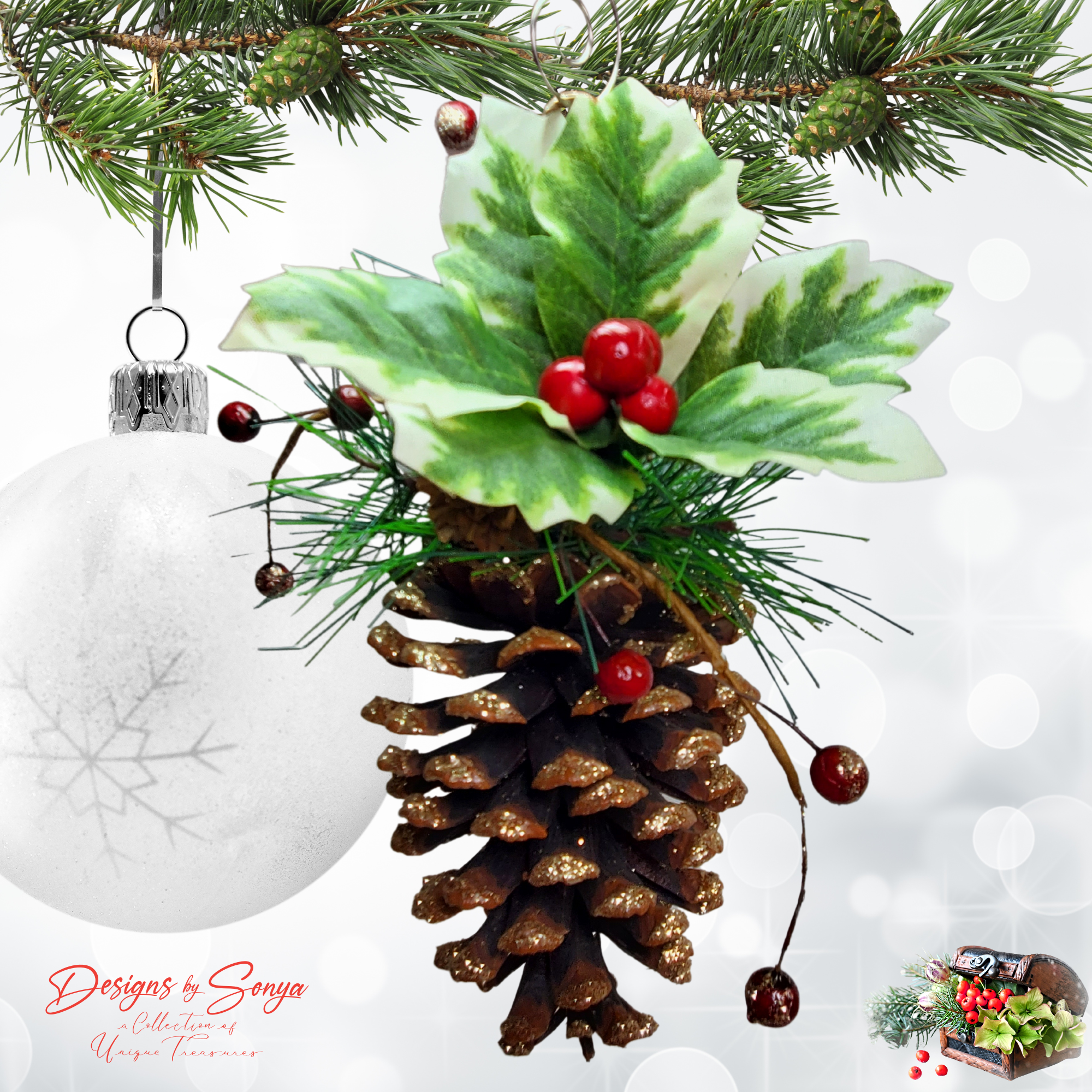 Pinecone Ornament with White Bauble Background
Handmade pinecone ornament decorated with green holly leaves, red berries, and gold glitter tips, hanging from a Christmas branch.
