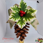Studio Front View with Burlap Ribbon
Front studio view of a handmade pinecone ornament featuring faux holly leaves, glossy red berries, burlap ribbon with pine print, green satin hanger and gold bell; rustic Christmas decoration.