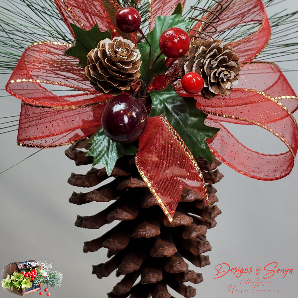 Close-Up of Ornament Front View
Detailed pinecone Christmas ornament featuring frosted pinecones, red ribbon bow with gold trim, glossy berries, and holiday greenery for festive farmhouse décor.