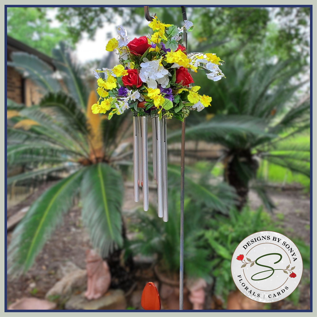Outdoor Display in Garden
Floral wind chime arrangement displayed outdoors, highlighting its vibrant blooms and melodic chimes.