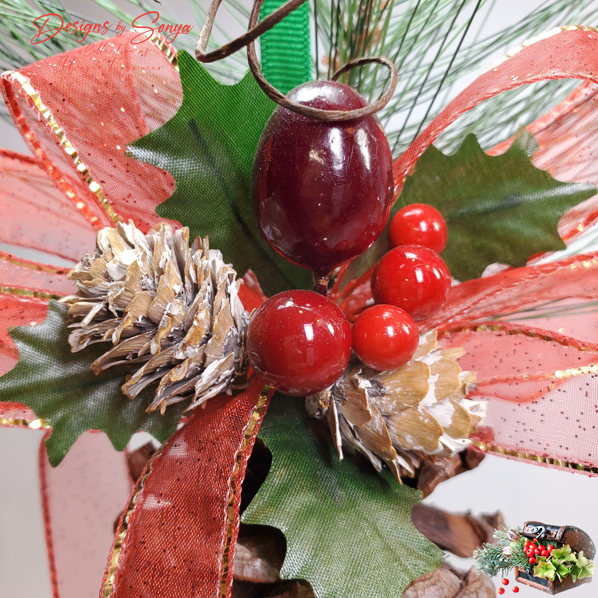 Close Detail of Berries and Ribbon
Zoomed detail of pinecone ornament highlighting glossy red berry picks, faux holly leaves, frosted pinecones, and glitter ribbon bow for farmhouse Christmas décor.