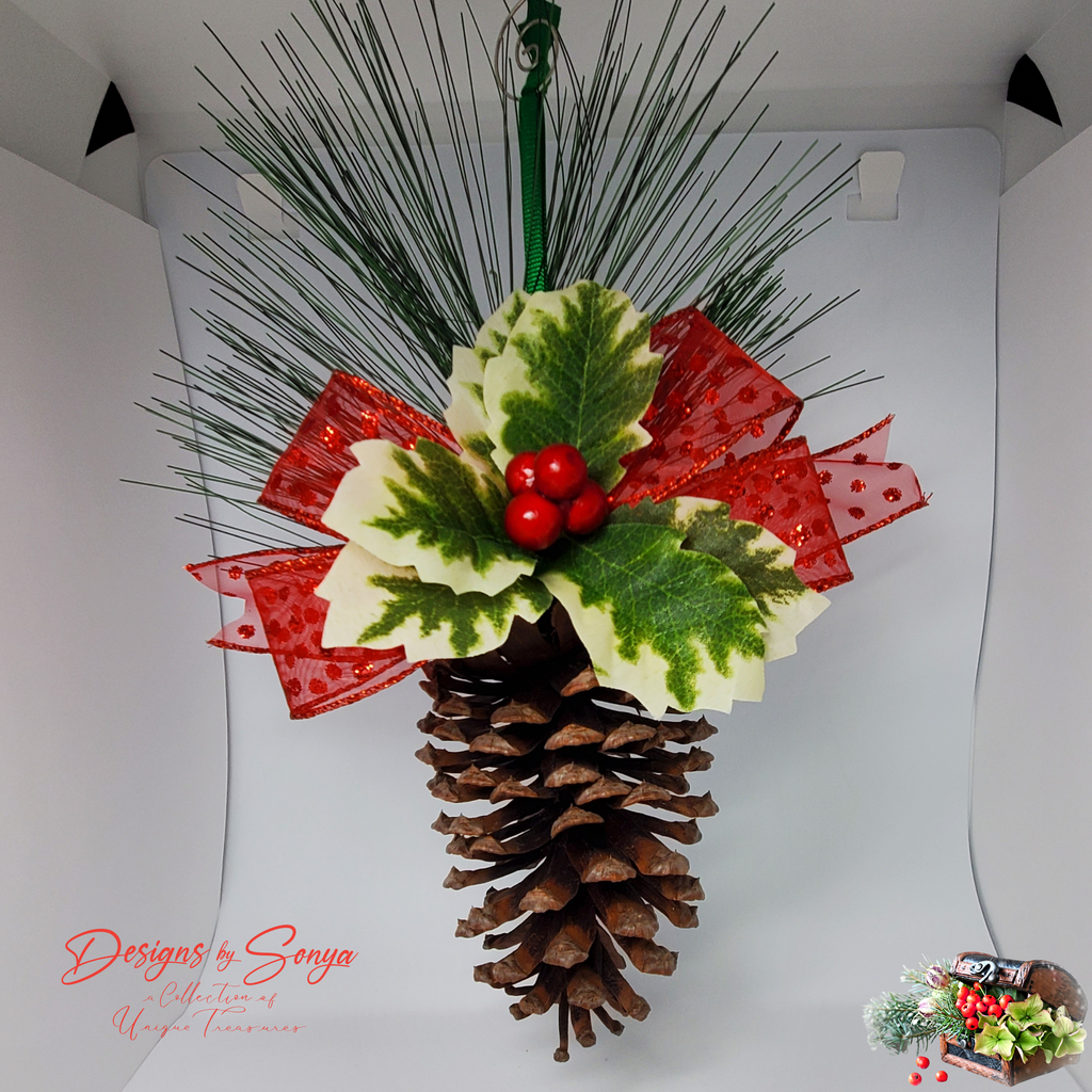 Studio Shot of Ornament
Clean background photo of handcrafted pinecone ornament with holly leaves, pine sprigs, and red bow for product detail clarity.