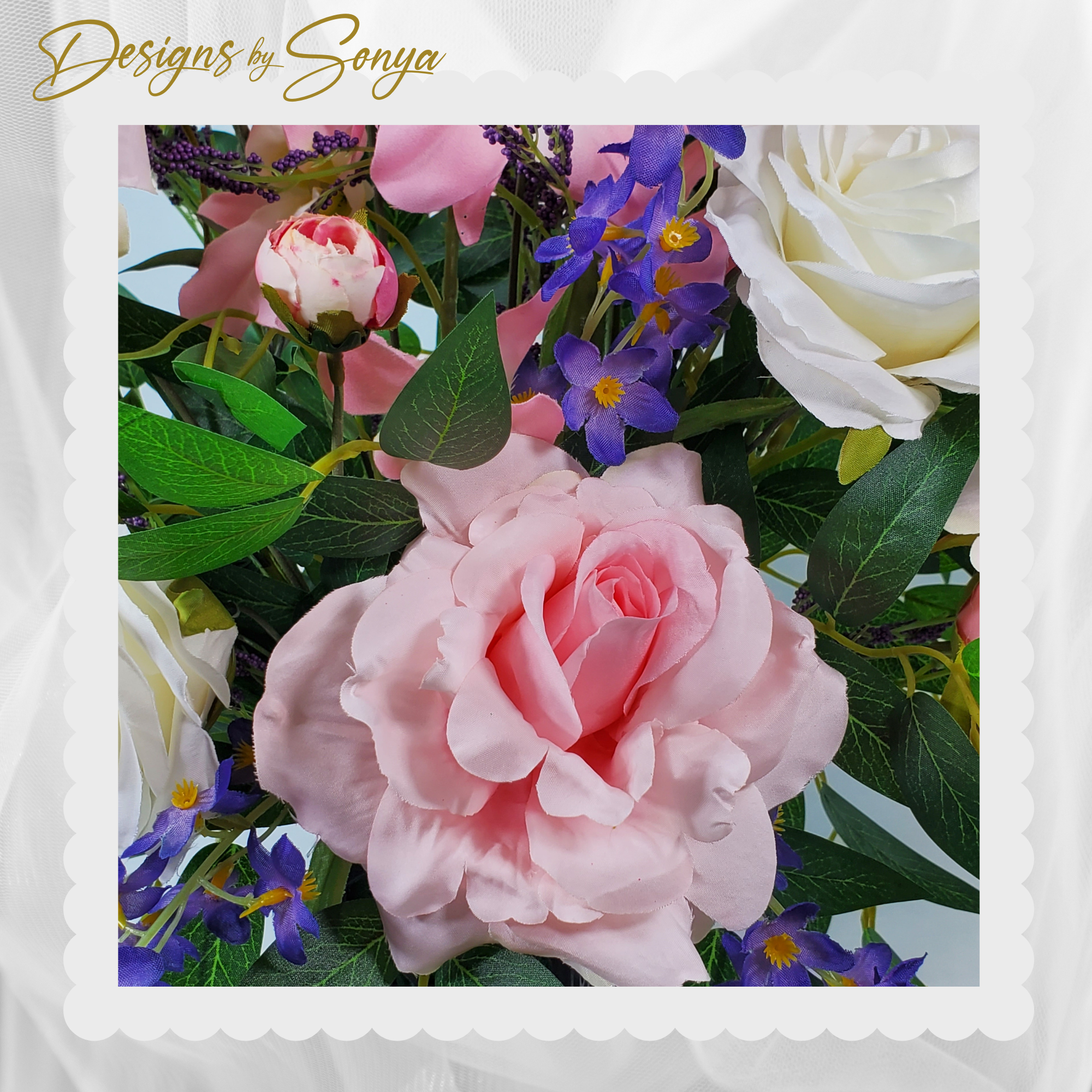 Pink Rose and Purple Accent Flowers
Silk pink rose in full bloom surrounded by delicate purple flowers and white roses with realistic greenery.